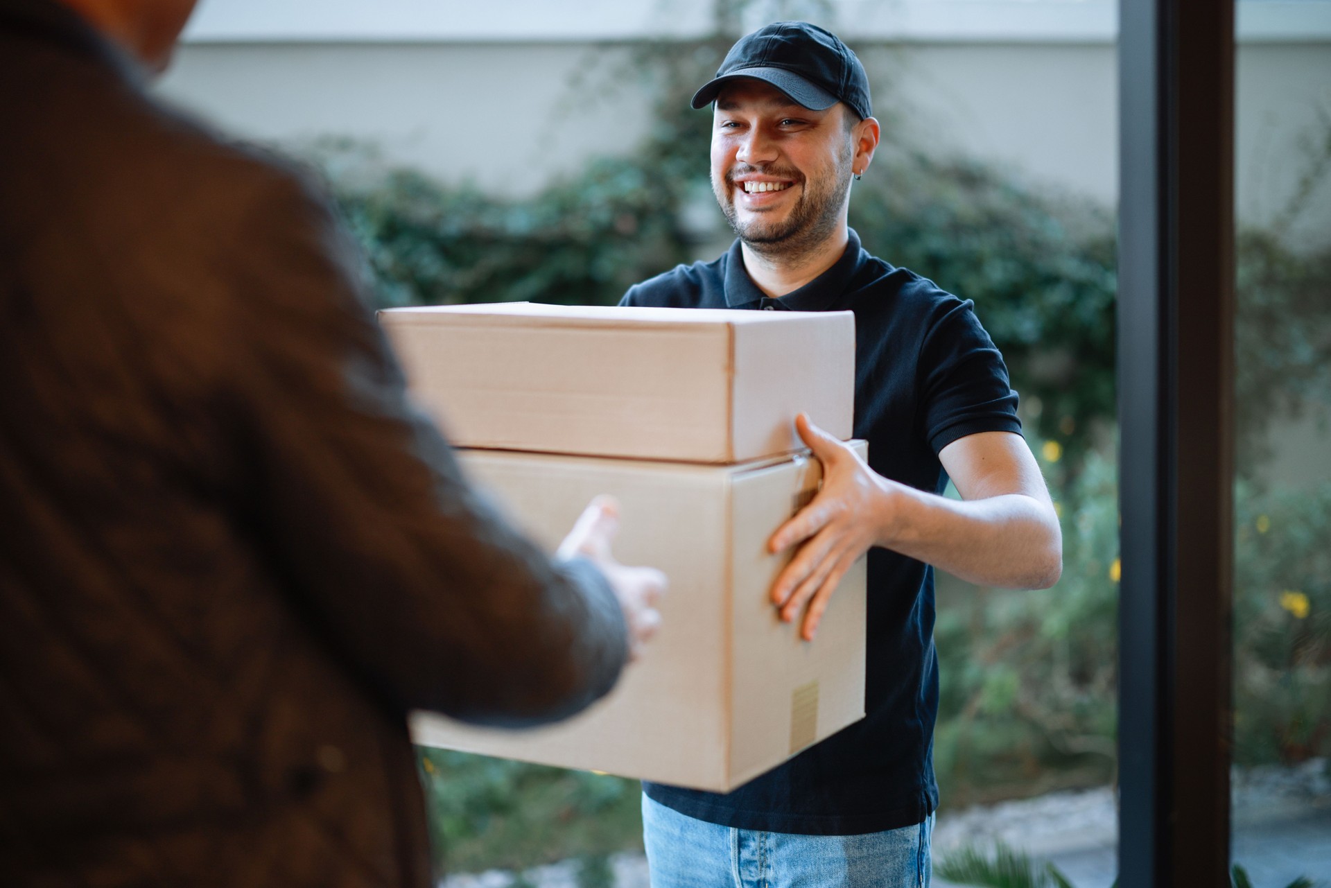 Courier handing off packages during same-delivery service 